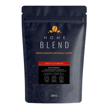 A 250g stand-up pouch of Home Blend Dark Honey coffee on a plain white background. The packaging is dark navy blue with gold and white text, and a red banner indicating the flavor 'Fruity & Punchy'.